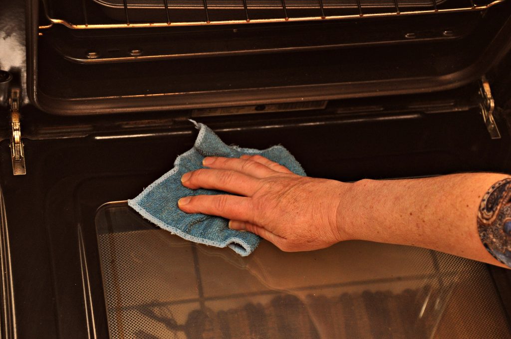 Man Cleaning Oven with Fibre Cloth
