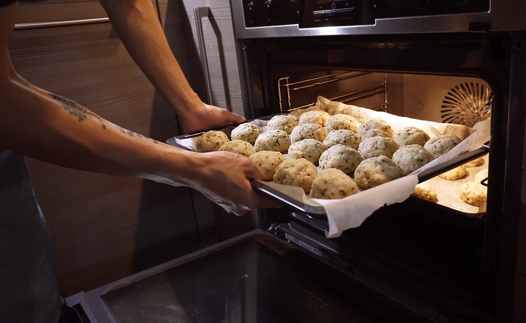 Man Putting Tray into Fan Oven