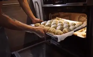 Man Putting Tray into Fan Oven