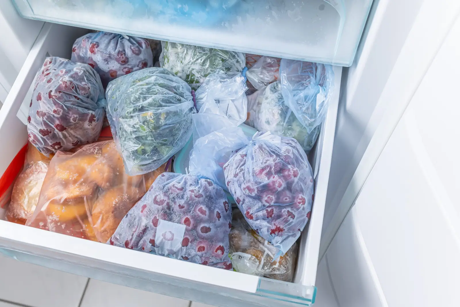 Frozen fruit and vegetables stored in a freezer drawer — frost-free technology keeps the interior ice-free without any manual defrosting